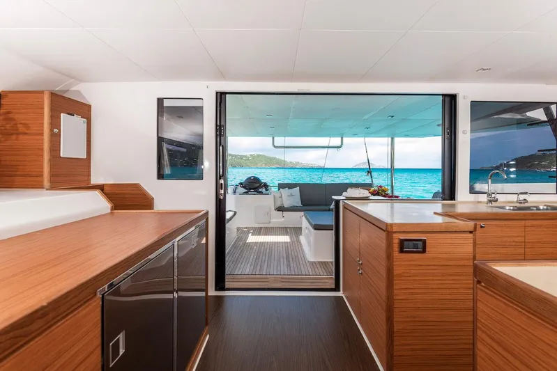  Yacht Photos Pics Interior of 2021 Dufour Catamarans 48, featuring modern kitchen and ocean view.