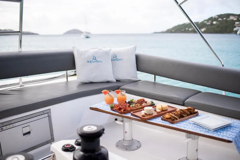  Yacht Photos Pics Luxurious 2021 Dufour Catamaran 48 with elegant outdoor dining setup and ocean view.