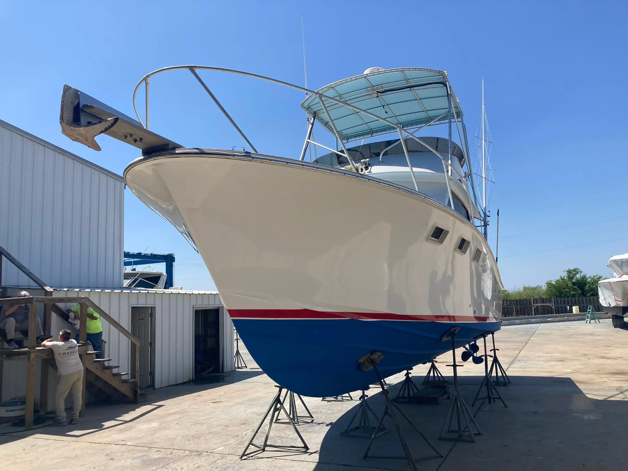 1975 Custom 36 Matlack Tournament SF boat on stands in a boatyard.