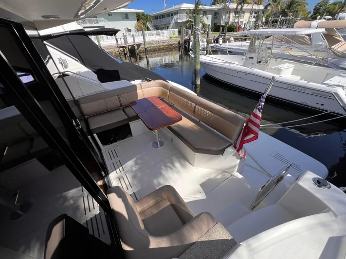  Yacht Photos Pics 2016 Sea Ray 400 Sundancer yacht with spacious deck and seating area, docked by the water.