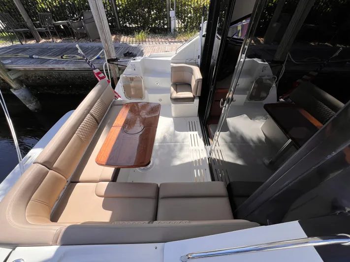  Yacht Photos Pics 2016 Sea Ray 400 Sundancer yacht with elegant seating and wooden table on deck.