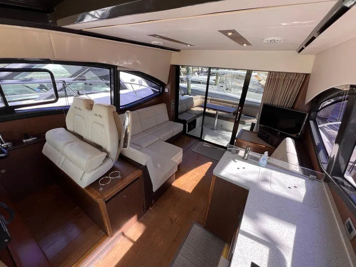  Yacht Photos Pics Luxurious interior of 2016 Sea Ray 400 Sundancer yacht with modern seating and large windows.