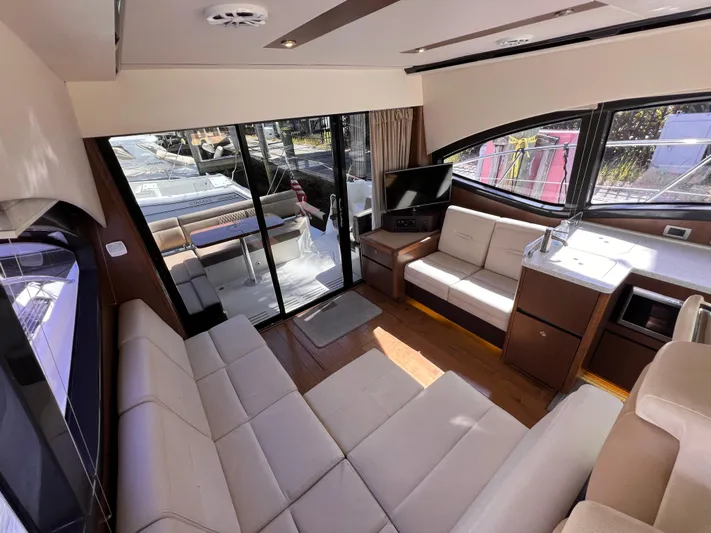  Yacht Photos Pics Luxurious interior of 2016 Sea Ray 400 Sundancer yacht with modern seating and entertainment area.