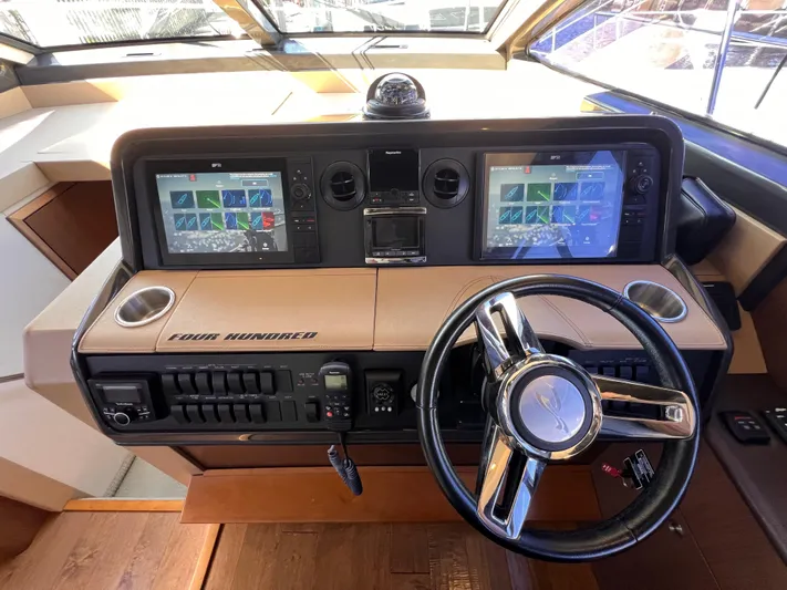  Yacht Photos Pics Helm of 2016 Sea Ray 400 Sundancer with dual navigation screens and steering wheel.