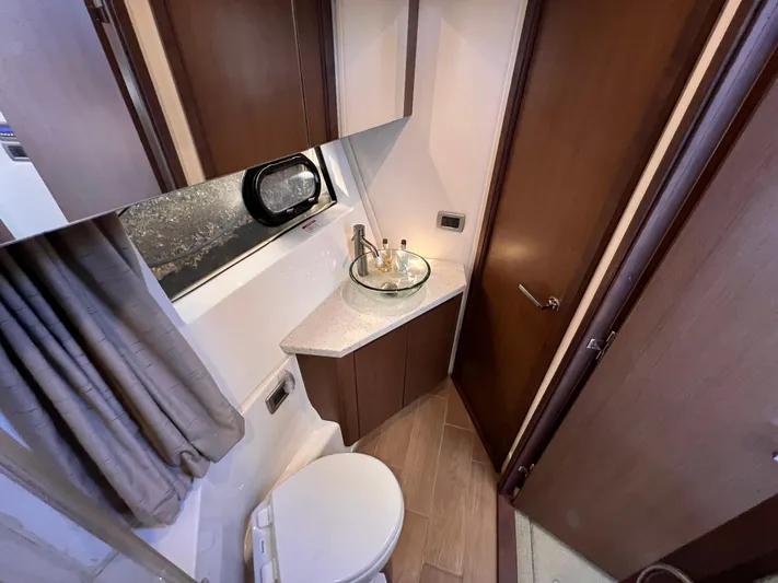  Yacht Photos Pics Interior of 2016 Sea Ray 400 Sundancer bathroom with modern fixtures and wood accents.