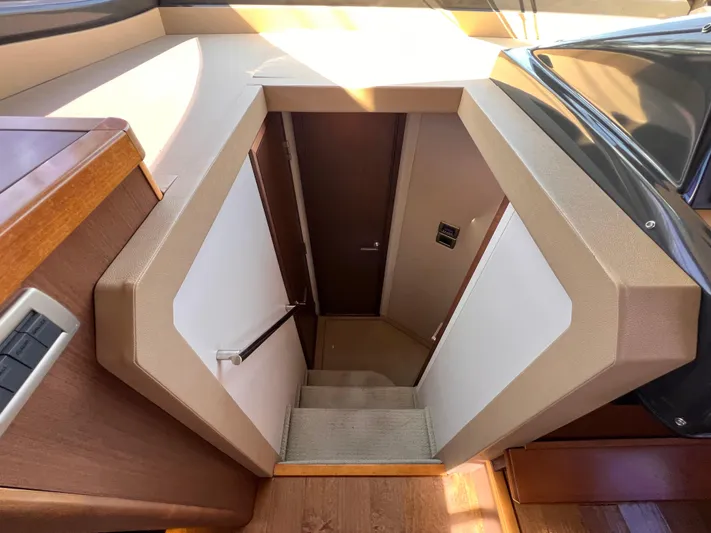  Yacht Photos Pics Stairway inside 2016 Sea Ray 400 Sundancer yacht, featuring modern wood and beige design.