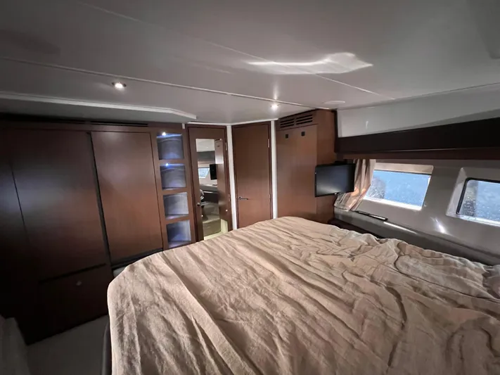  Yacht Photos Pics Luxurious cabin interior of 2016 Sea Ray 400 Sundancer yacht with bed and TV.