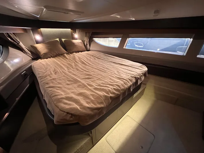  Yacht Photos Pics Luxurious bedroom interior of 2016 Sea Ray 400 Sundancer yacht with large bed and windows.