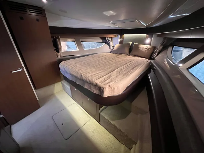  Yacht Photos Pics Luxurious cabin interior of 2016 Sea Ray 400 Sundancer yacht with cozy bed and modern design.