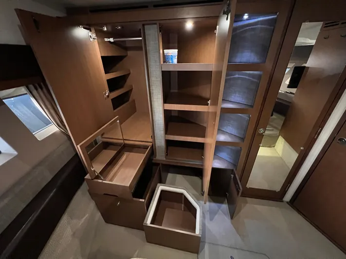  Yacht Photos Pics 2016 Sea Ray 400 Sundancer interior with open wooden cabinets and storage compartments.