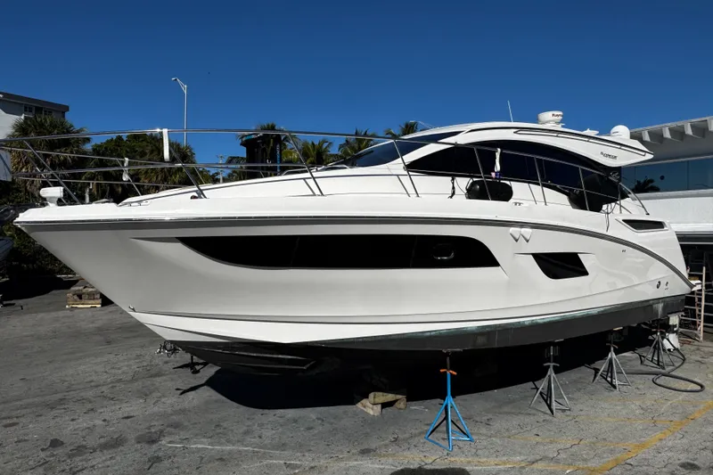  Yacht Photos Pics 2016 Sea Ray 400 Sundancer yacht on dry dock under clear blue sky.