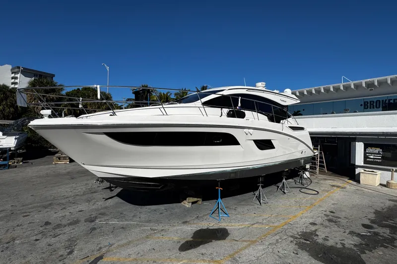  Yacht Photos Pics 2016 Sea Ray 400 Sundancer yacht on dry dock under clear blue sky.