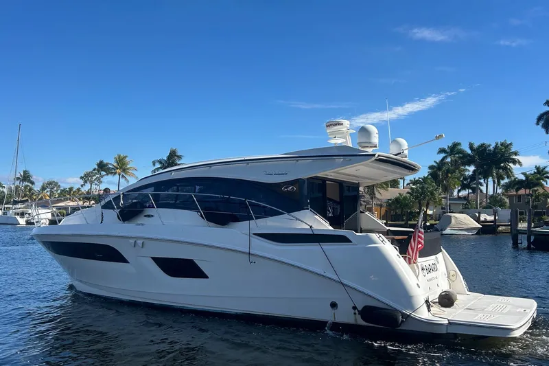  Yacht Photos Pics 2016 Sea Ray 400 Sundancer yacht docked in a sunny marina with palm trees.