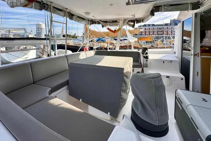 Alegria Yacht Photos Pics 2017 Outremer 51 catamaran cockpit with gray seating and marina view.