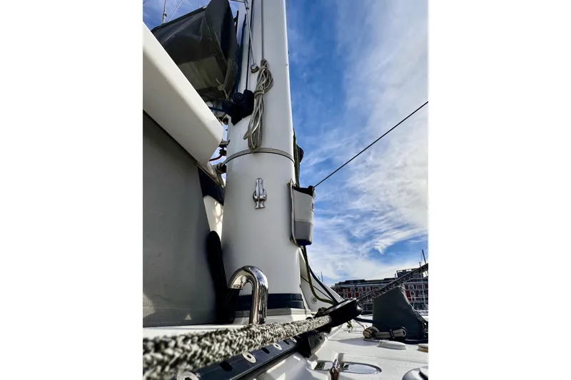 Alegria Yacht Photos Pics 2017 Outremer 51 sailboat mast against a blue sky with clouds.