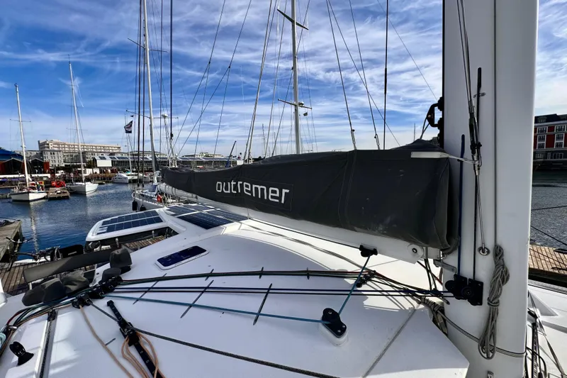 Alegria Yacht Photos Pics 2017 Outremer 51 catamaran docked at marina with clear blue sky.