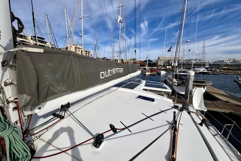 Alegria Yacht Photos Pics 2017 Outremer 51 catamaran docked at marina with clear blue sky.