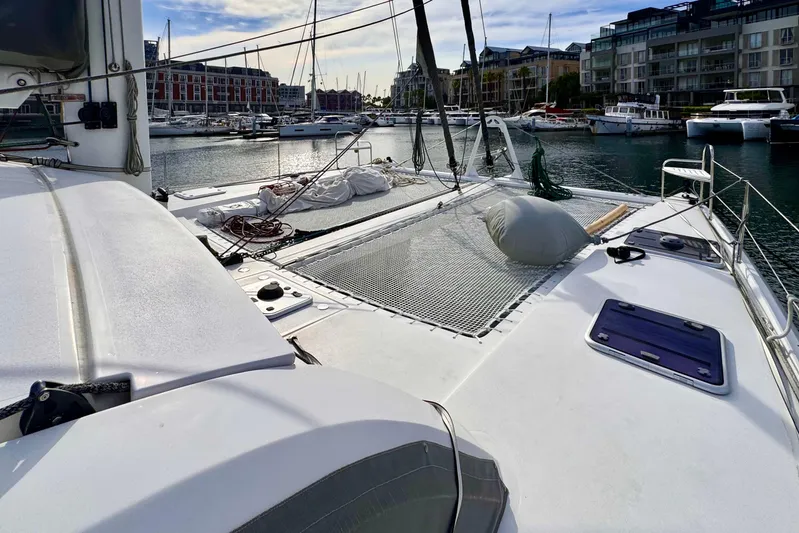 Alegria Yacht Photos Pics 2017 Outremer 51 catamaran docked in a marina, showcasing deck and netting.