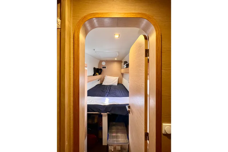 Alegria Yacht Photos Pics Cozy cabin interior of 2017 Outremer 51 sailboat with wooden finish and bed.