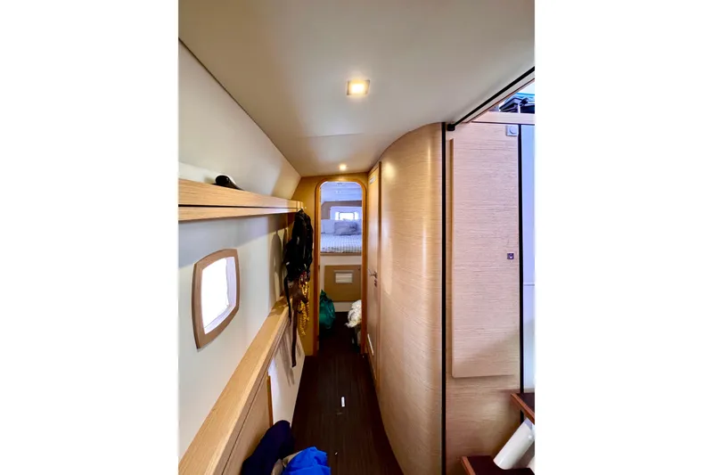 Alegria Yacht Photos Pics Interior hallway of 2017 Outremer 51 yacht, featuring modern wood finishes and cozy design.