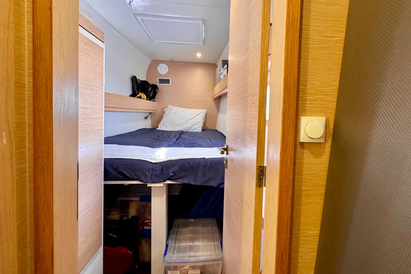 Alegria Yacht Photos Pics Cozy cabin interior of 2017 Outremer 51 yacht with wooden finishes and storage.