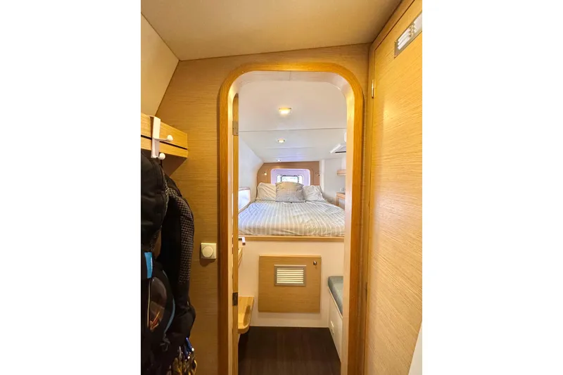 Alegria Yacht Photos Pics Cozy cabin interior of 2017 Outremer 51 yacht with bed and wooden accents.