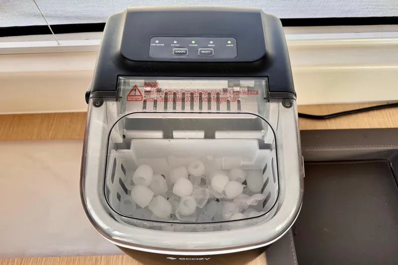 Alegria Yacht Photos Pics Portable ice maker on 2017 Outremer 51 yacht, filled with ice cubes.