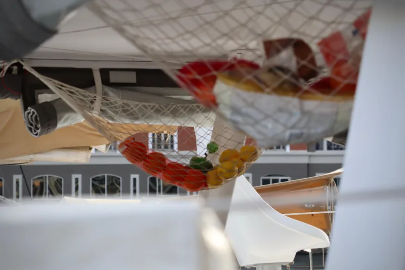 Alegria Yacht Photos Pics Hanging fruit net on 2017 Outremer 51 catamaran, showcasing onboard storage.