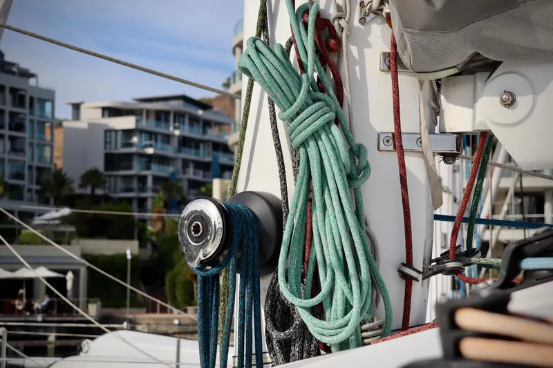 Alegria Yacht Photos Pics Close-up of ropes and winch on a 2017 Outremer 51 sailboat, with urban background.