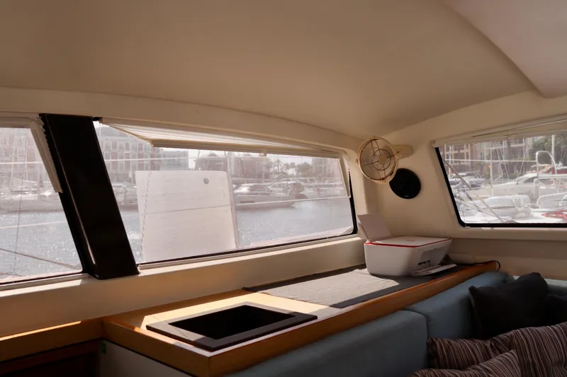 Alegria Yacht Photos Pics Interior view of 2017 Outremer 51 catamaran with large windows and cozy seating area.