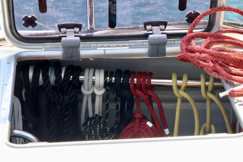 Alegria Yacht Photos Pics Storage compartment with neatly organized ropes on a 2017 Outremer 51 sailboat.