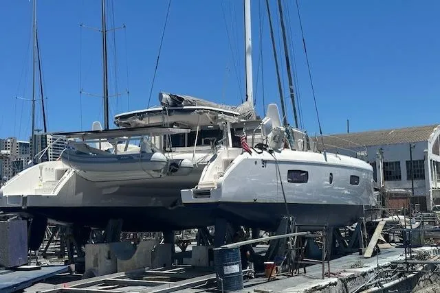 Alegria Yacht Photos Pics 2017 Outremer 51 catamaran on dry dock, with blue sky background.