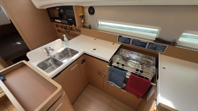  Yacht Photos Pics Modern kitchen in 2022 Jeanneau Sun Odyssey 410 yacht with dual sinks and stove.
