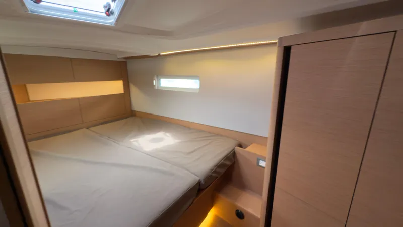  Yacht Photos Pics Cozy cabin interior of 2022 Jeanneau Sun Odyssey 410 sailboat with modern design.