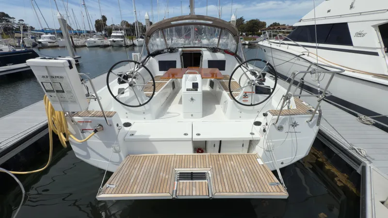  Yacht Photos Pics 2022 Jeanneau Sun Odyssey 410 docked, featuring dual steering wheels and spacious deck.