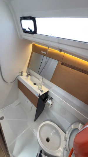  Yacht Photos Pics Modern bathroom in 2022 Jeanneau Sun Odyssey 410 yacht with sleek design and fixtures.
