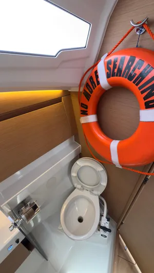  Yacht Photos Pics 2022 Jeanneau Sun Odyssey 410 bathroom with life preserver and modern fixtures.