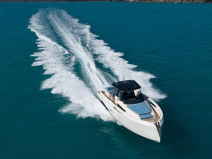 400 Wa Yacht Photos Pics 2025 Cayman Yachts 400 WA cruising on clear blue water, leaving a wake behind.