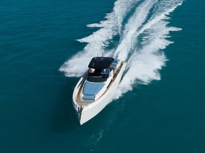 400 Wa Yacht Photos Pics 2025 Cayman Yachts 400 WA cruising on clear blue water, aerial view.