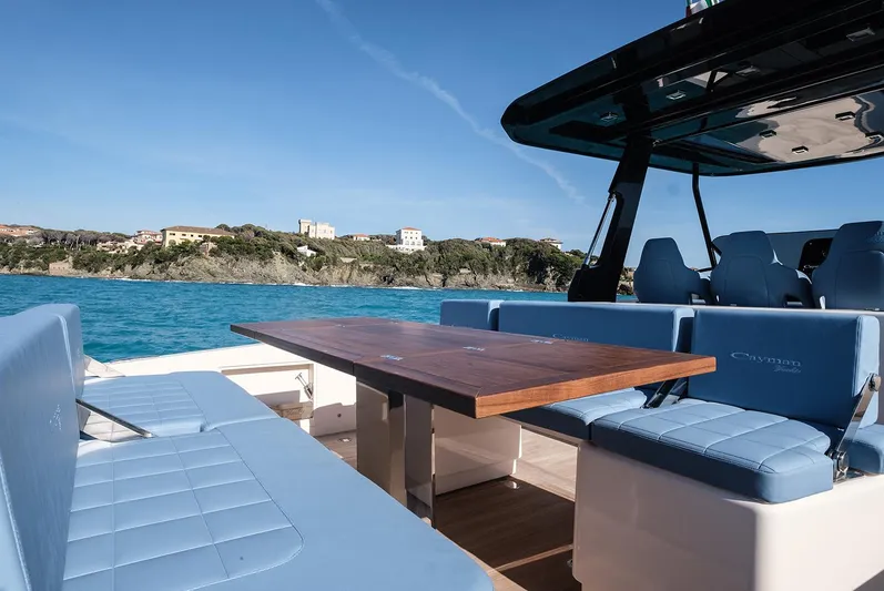 400 Wa Yacht Photos Pics Luxurious Cayman Yachts 400 WA 2025 with elegant seating and scenic coastal view.