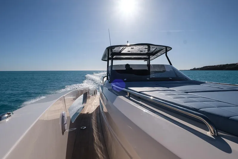 400 Wa Yacht Photos Pics 2025 Cayman Yachts 400 WA cruising on clear blue waters under a bright sun.