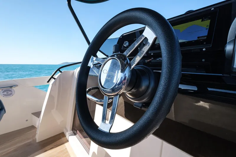 400 Wa Yacht Photos Pics Steering wheel of 2025 Cayman Yachts 400 WA, with ocean view in background.