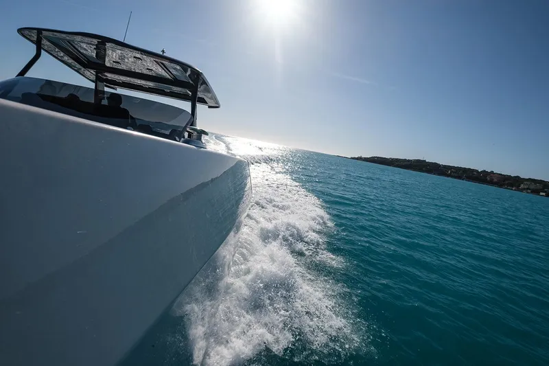 400 Wa Yacht Photos Pics 2025 Cayman Yachts 400 WA cruising on clear blue waters under bright sun.