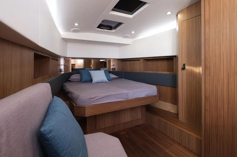 400 Wa Yacht Photos Pics Luxurious cabin interior of 2025 Cayman Yachts 400 WA with modern wood finish and cozy bedding.