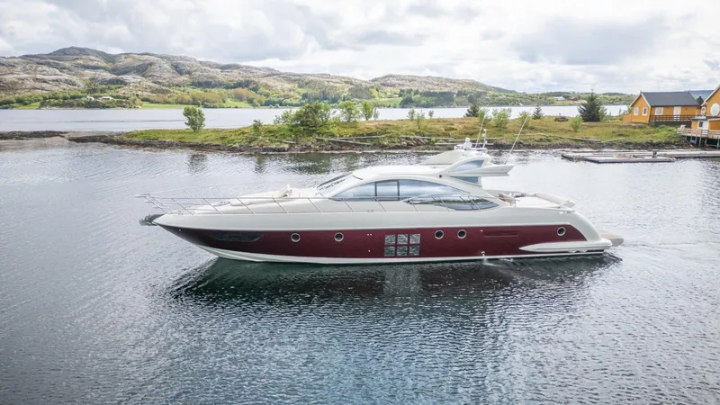  Yacht Photos Pics 2008 Azimut 62S yacht cruising on a scenic lake with mountains in the background.