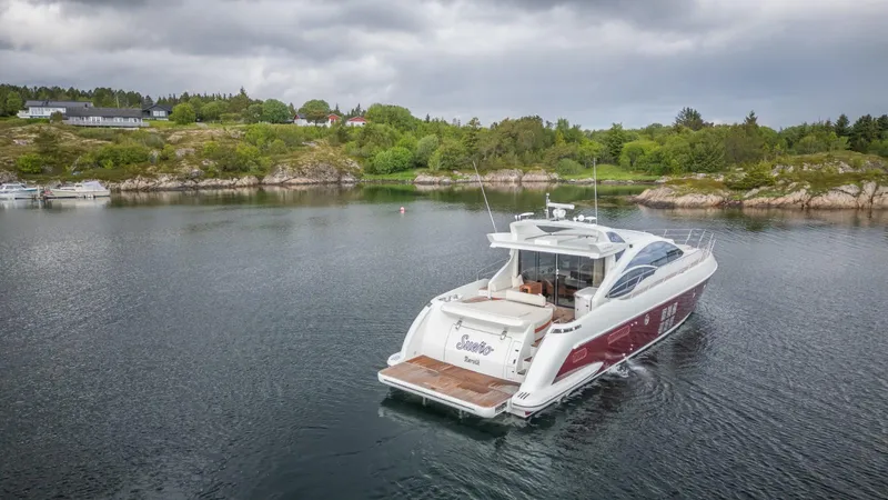  Yacht Photos Pics 2008 Azimut 62S yacht cruising in a serene, scenic bay with lush greenery.