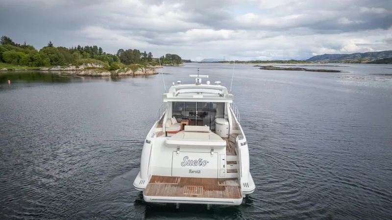  Yacht Photos Pics 2008 Azimut 62S yacht cruising in scenic waters with lush greenery and cloudy skies.