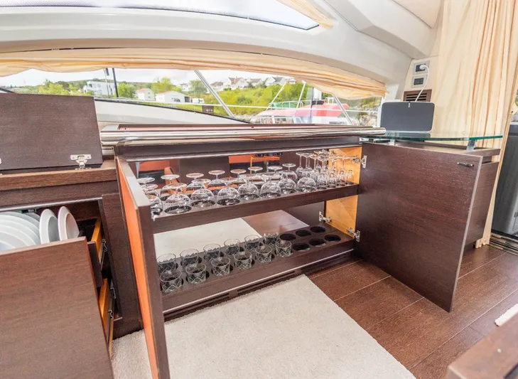  Yacht Photos Pics Luxurious interior of 2008 Azimut 62S yacht with glassware storage and elegant wood cabinetry.