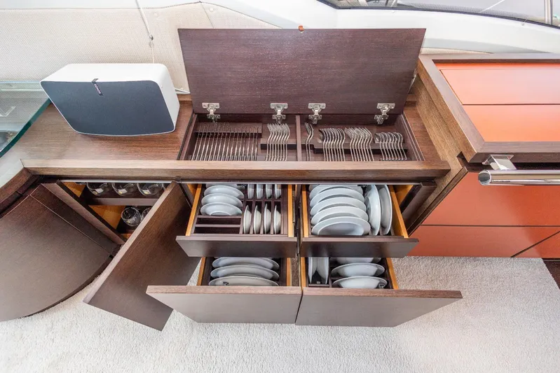  Yacht Photos Pics Luxury yacht kitchen with organized cutlery and dish storage, Azimut 62S 2008 model.