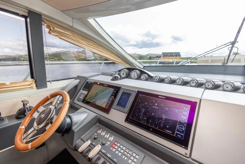  Yacht Photos Pics Helm of 2008 Azimut 62S yacht with navigation screens and wooden steering wheel.